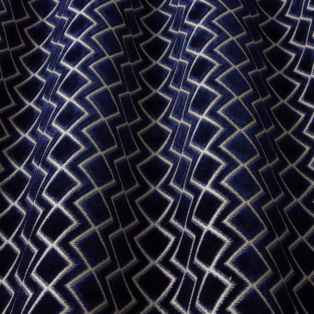 Deep navy geometric velvet with pale outline pattern and soft sheen