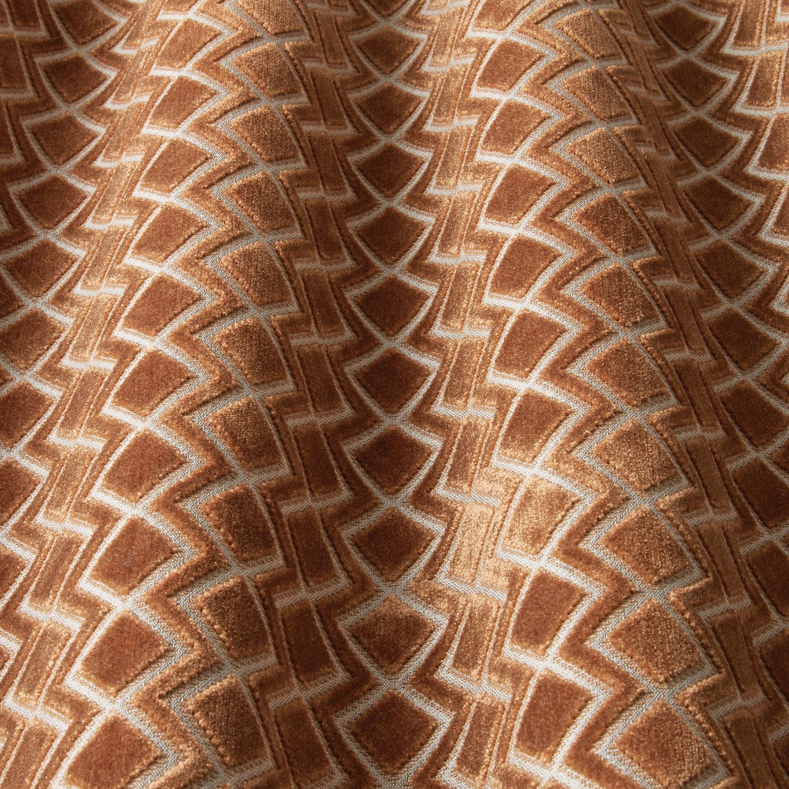 Terracotta geometric velvet swatch with wavy chevron outlines and soft sheen