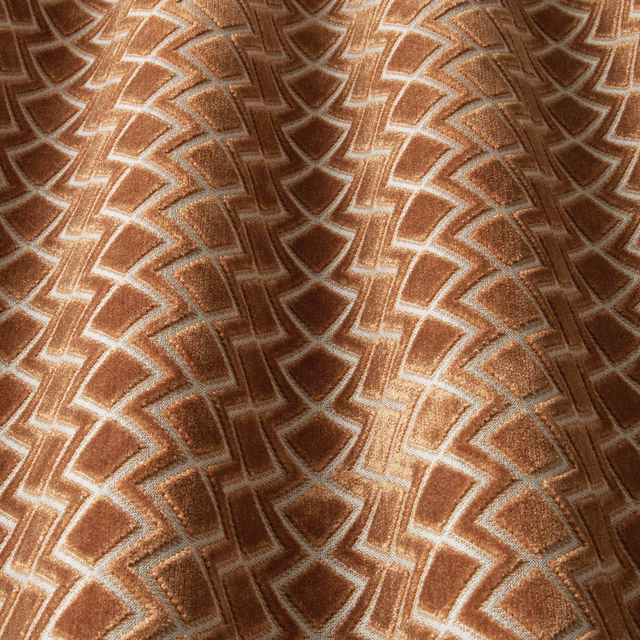 Terracotta geometric velvet swatch with wavy chevron outlines and soft sheen
