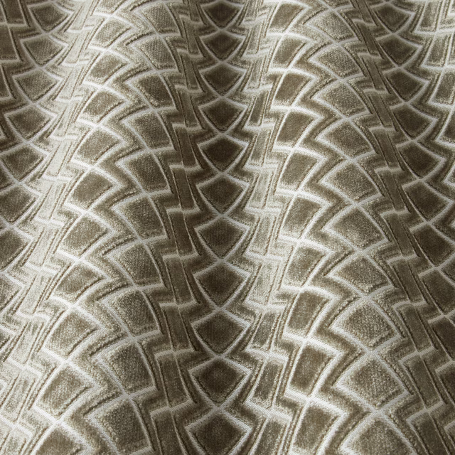 Taupe velvet swatch with repeating wavy geometric arcs and soft sheen