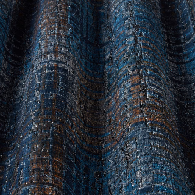 Close-up of a midnight blue velvet with wavy teal and copper texture