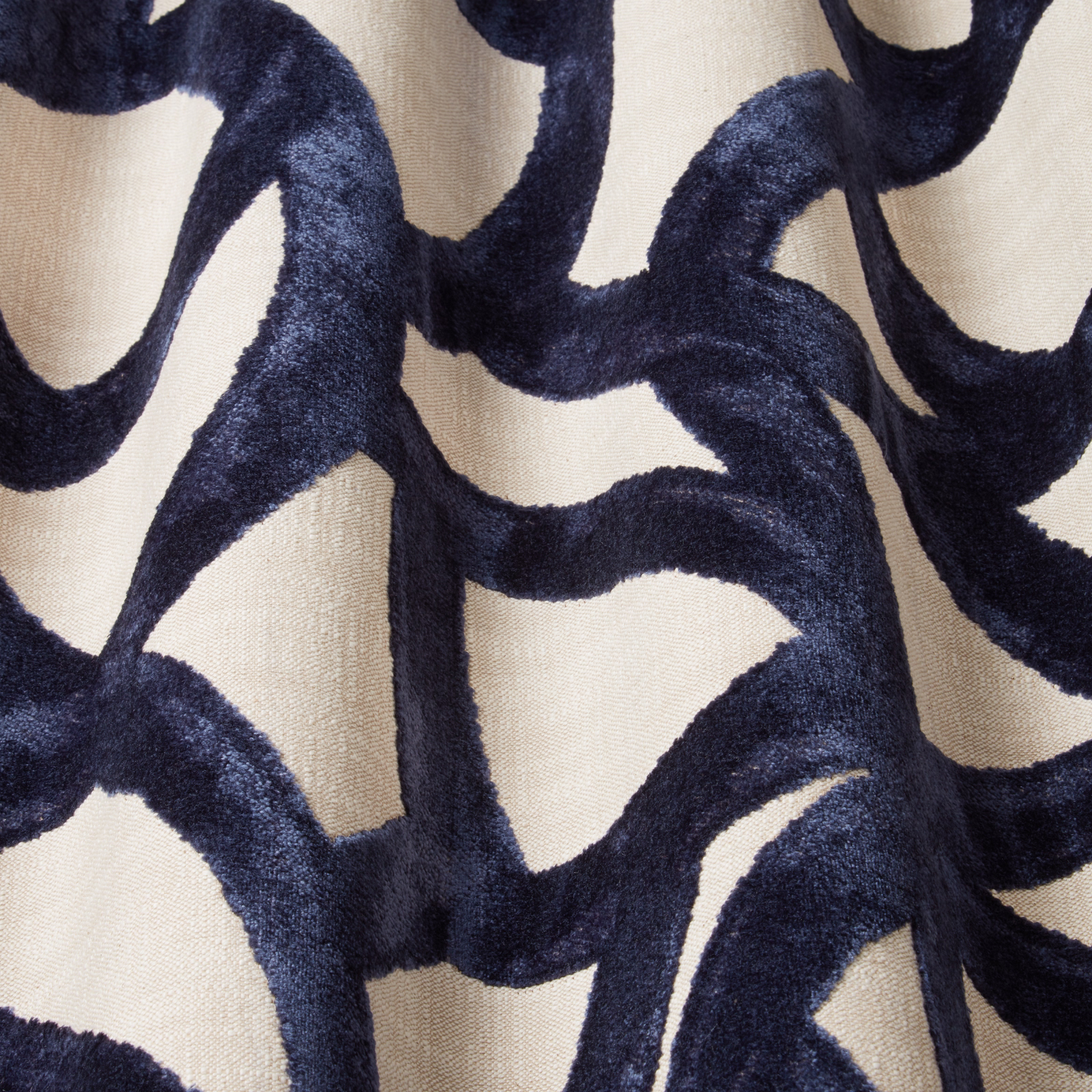 Deep midnight-blue velvet wavy motif on a pale ivory ground
