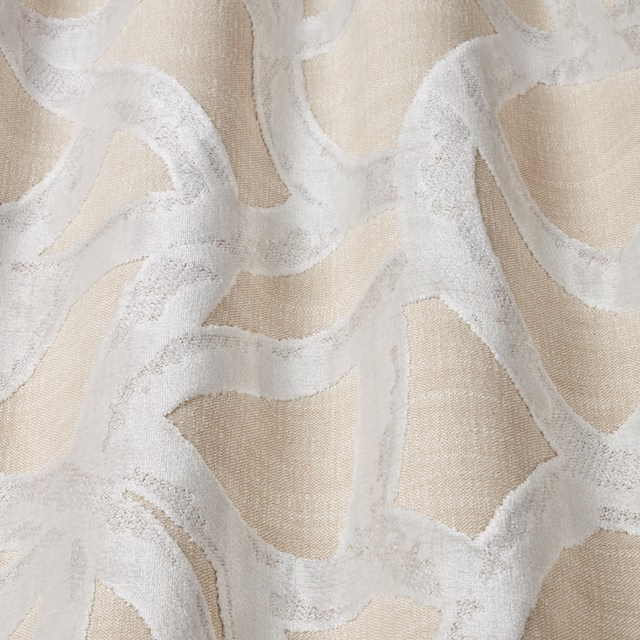 Cream velvet fabric with large flowing platinum wavy motif