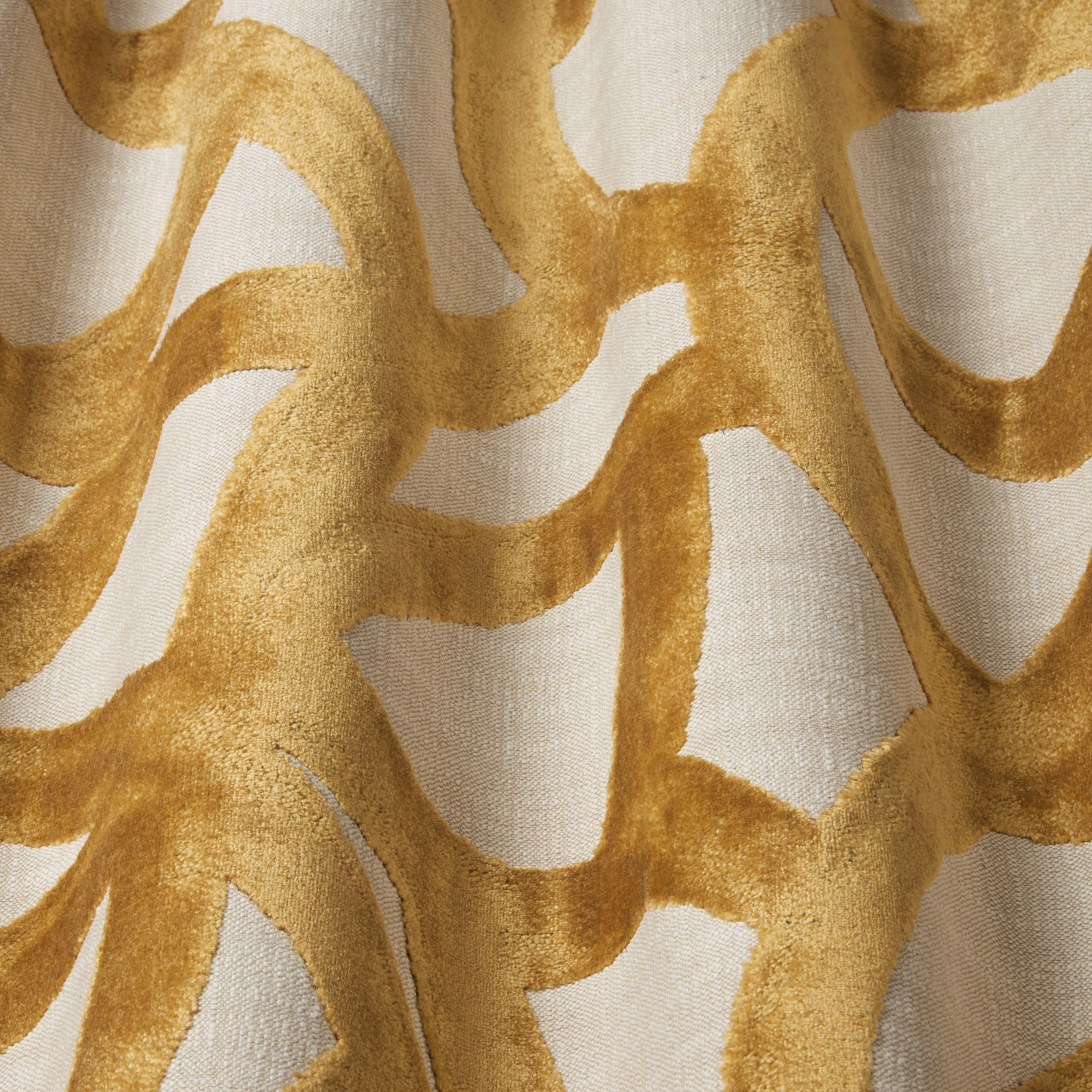 Close-up of saffron-gold wavy velvet pattern on a pale neutral ground