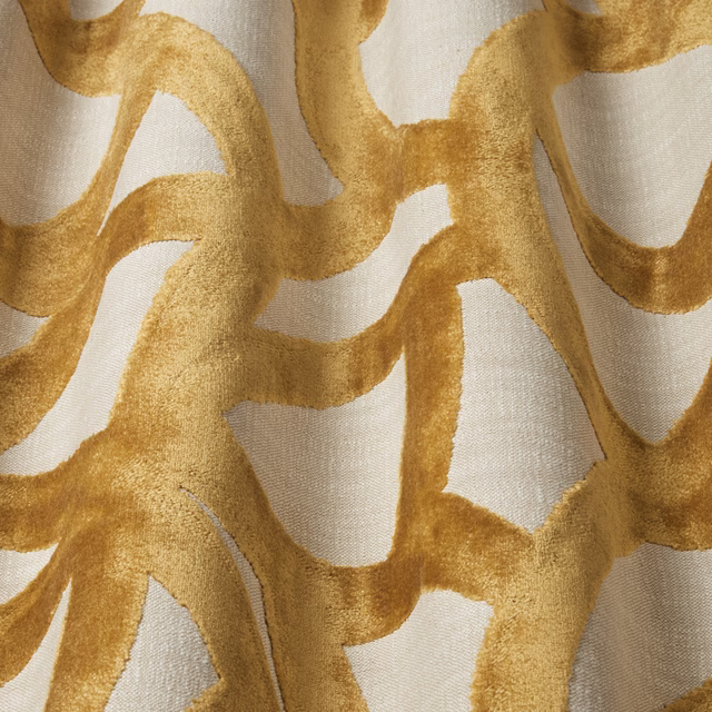 Close-up of saffron-gold wavy velvet pattern on a pale neutral ground