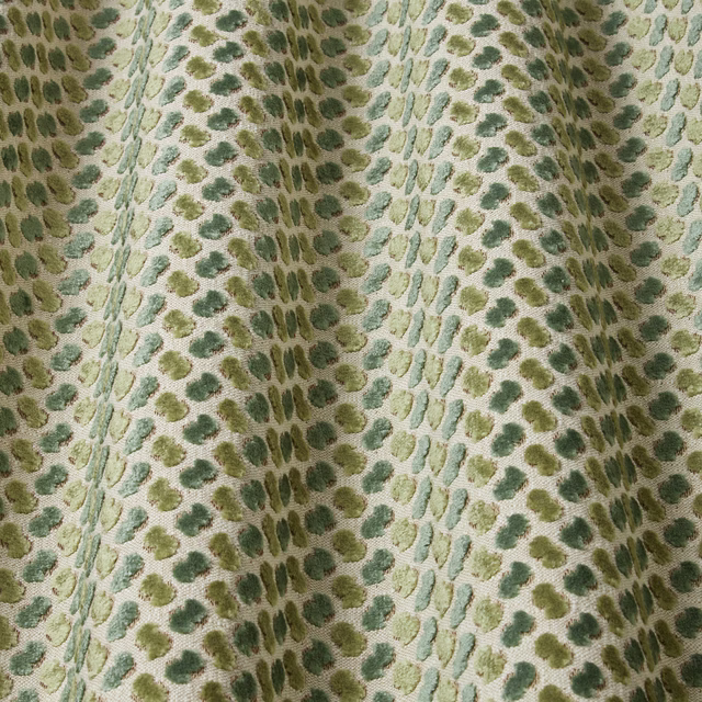 Pale velvet fabric with wavy jade, sage and olive oval motifs