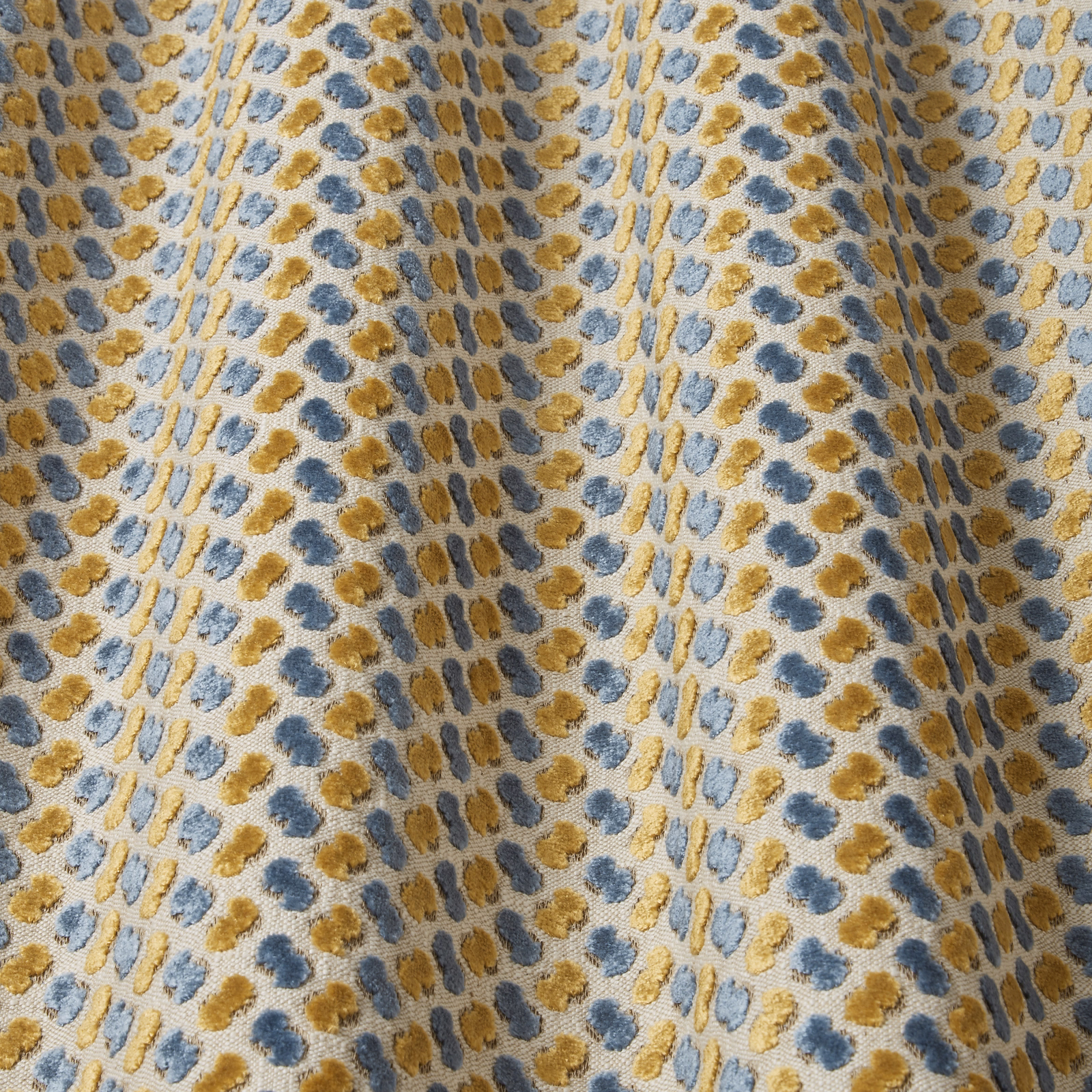 Teal velvet swatch with gold and blue wavy dotted motif