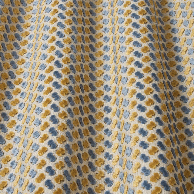 Teal velvet swatch with gold and blue wavy dotted motif
