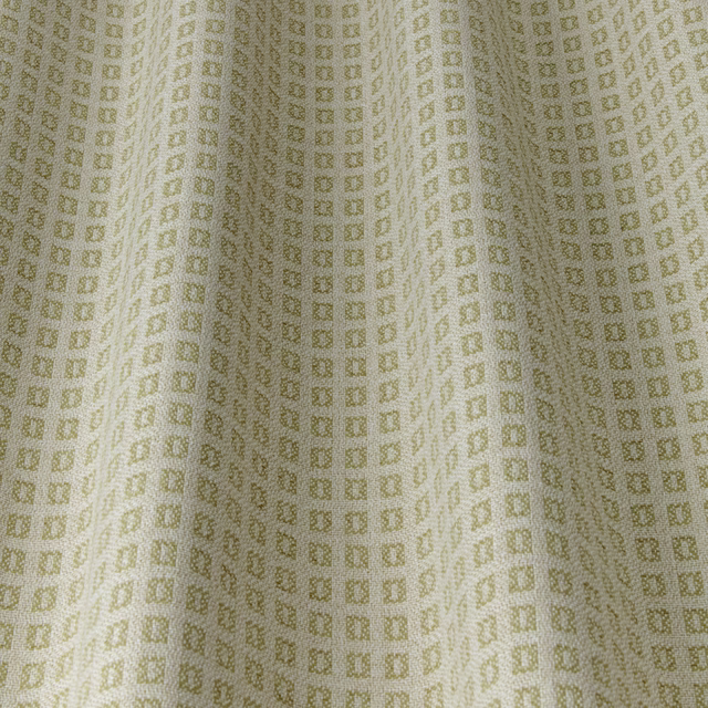 Pale cream fabric swatch with tiny willow-green square geometric repeat
