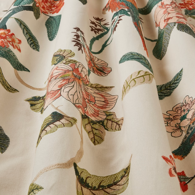 Ivory tapestry fabric with embroidered birds of paradise and leafy stems