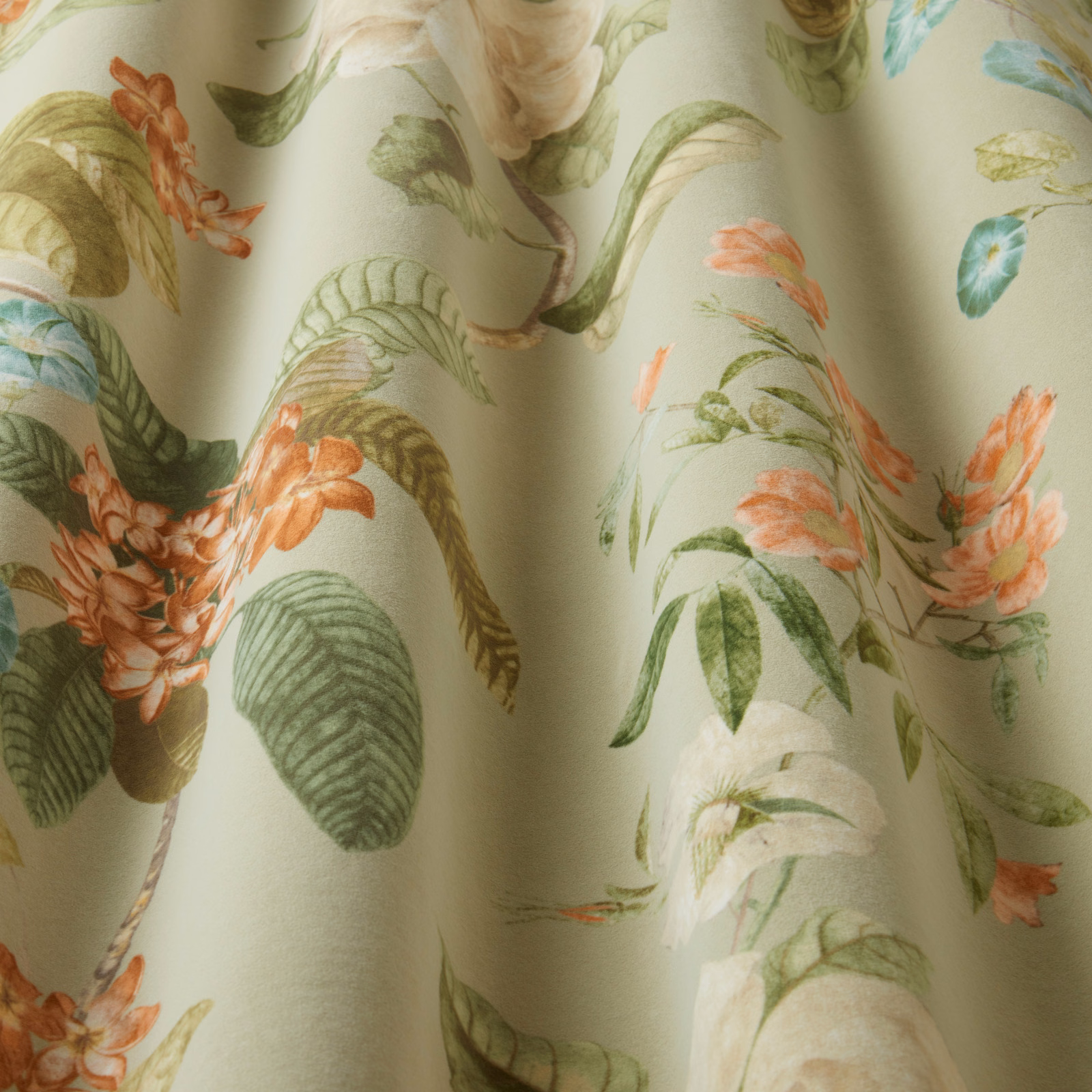 Pistachio botanical fabric with trailing leaves and coral flowers