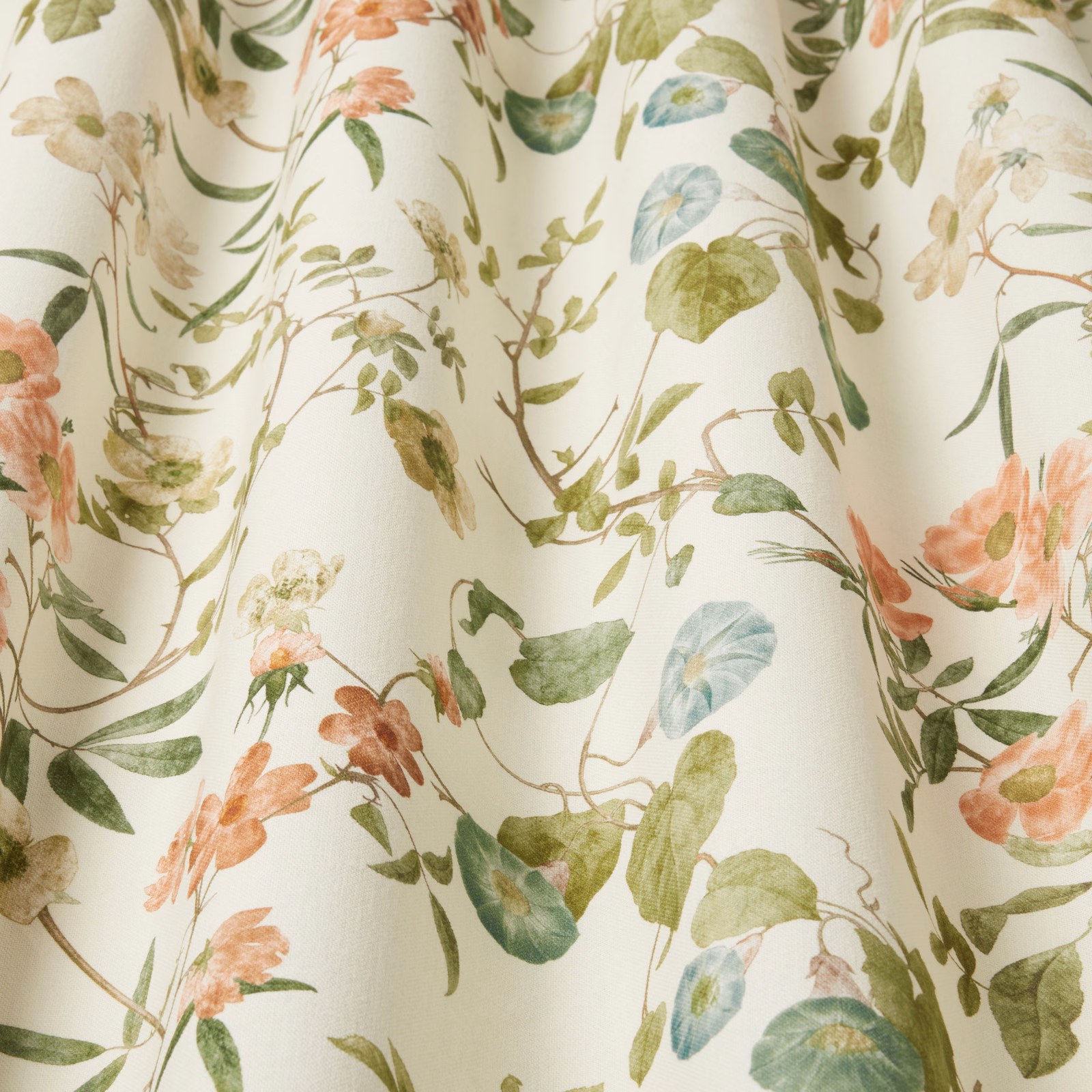 Painterly botanical fabric with papaya flowers, green leaves and pale aqua accents