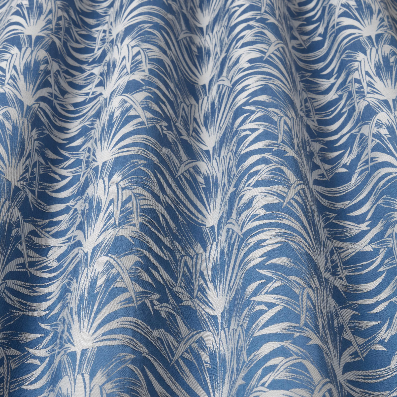 Blue and white wavy leaf-pattern fabric with a crisp woven texture
