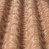 Papaya-orange woven fabric with creamy wavy leaf motif and soft drape