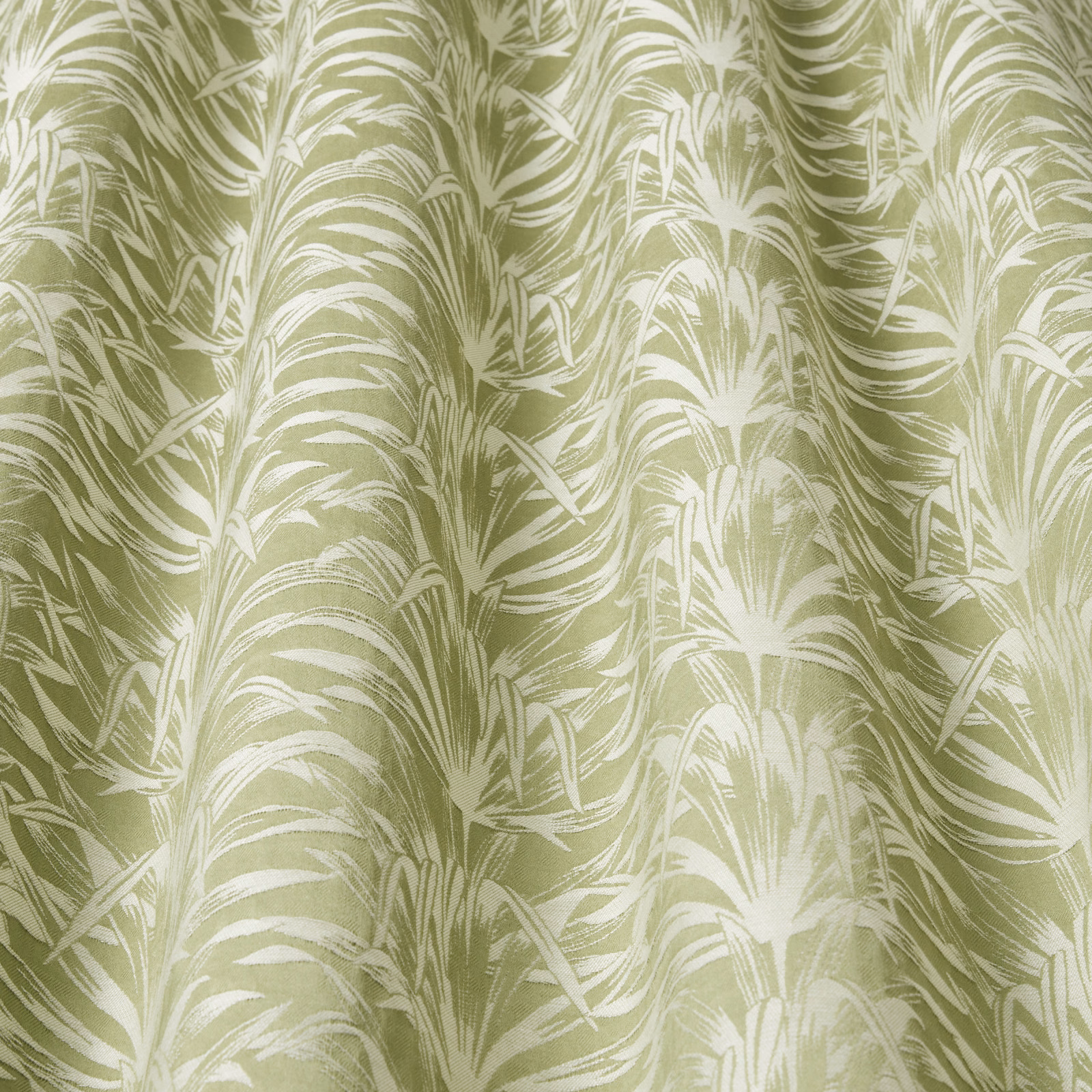 Pistachio green fabric with creamy wavy leaf pattern and soft sheen