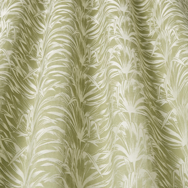 Pistachio green fabric with creamy wavy leaf pattern and soft sheen