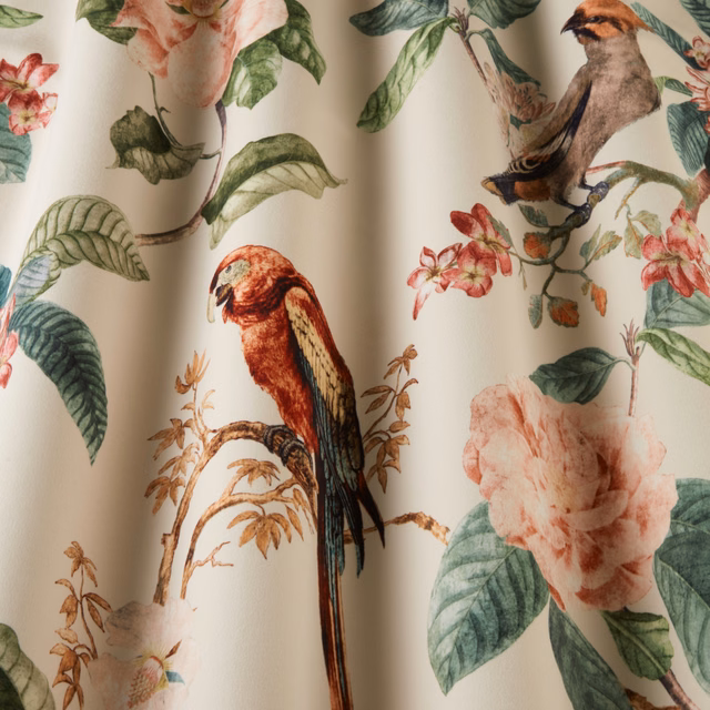 Ivory botanical fabric with parrots, roses and trailing green leaves