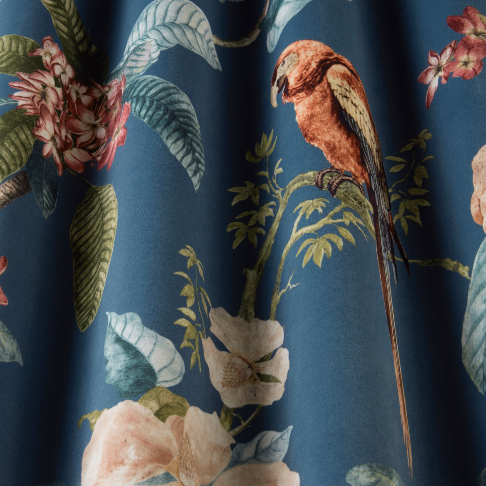 Printed bird and florals on deep teal-blue fabric with a smooth finish