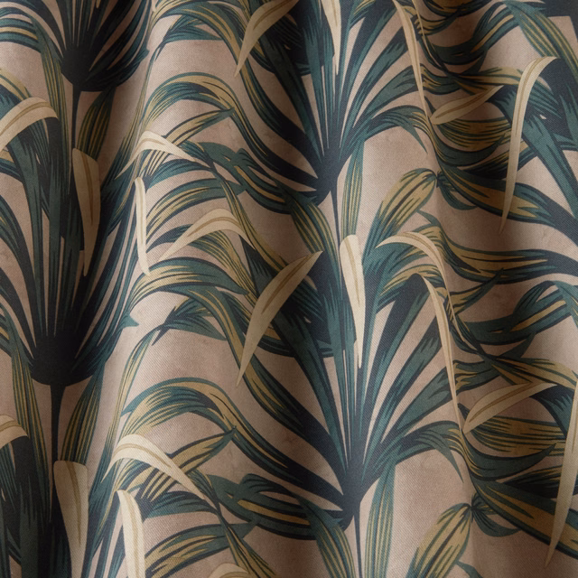 Large-scale tropical leaf print in deep teal, olive and beige on a warm neutral ground