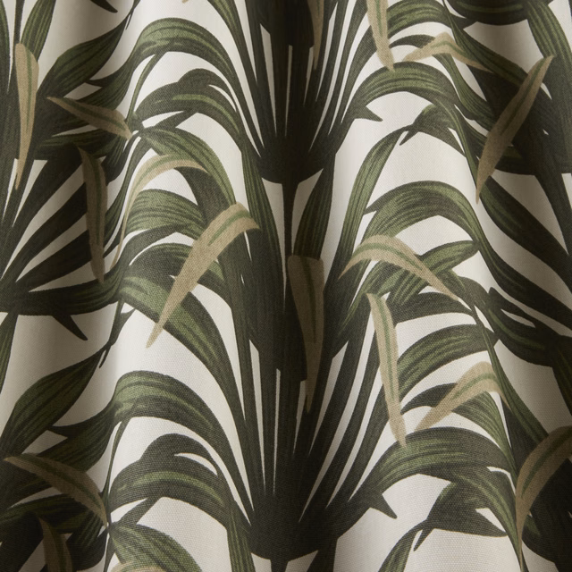Large palm-leaf print in dark and moss green on a cream ground
