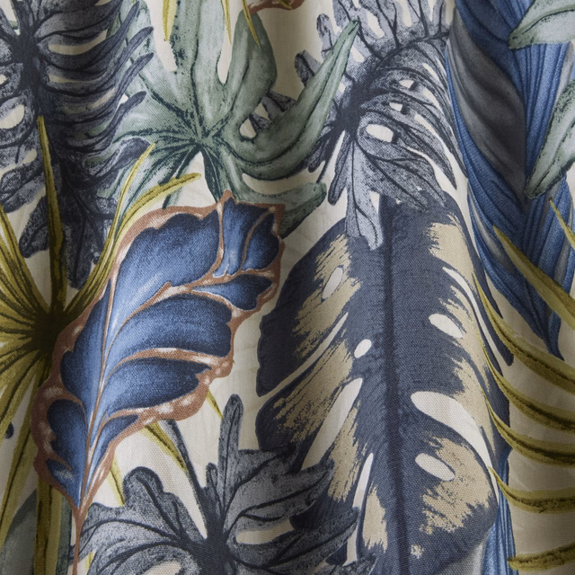 Close-up of tropical leaf print in misty blue, sage green and charcoal