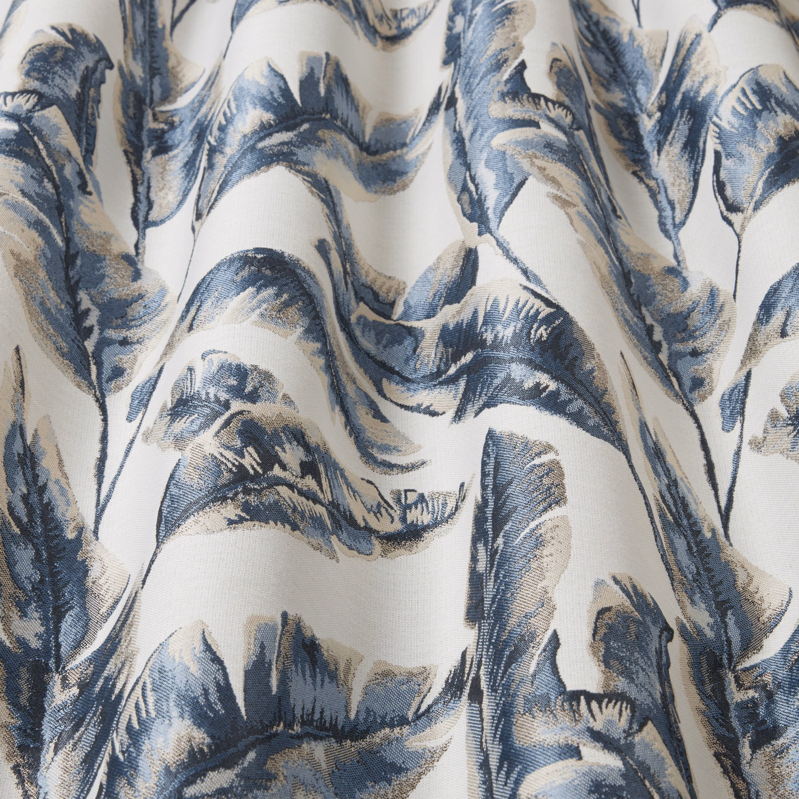 Blue and beige leaf-wave fabric on an ivory ground with a crisp woven texture