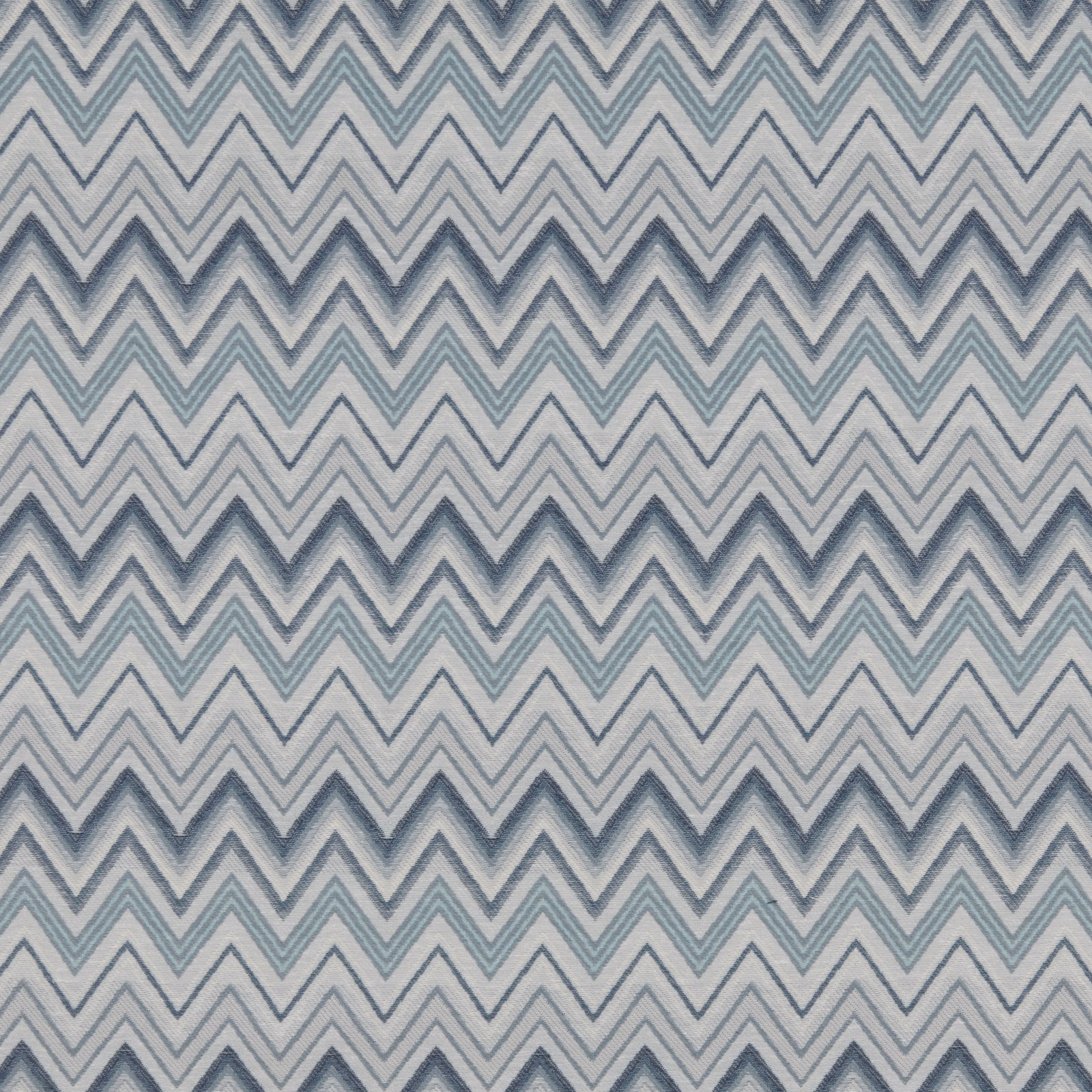 Blue-grey chevron fabric with soft aqua zigzags on an ivory ground