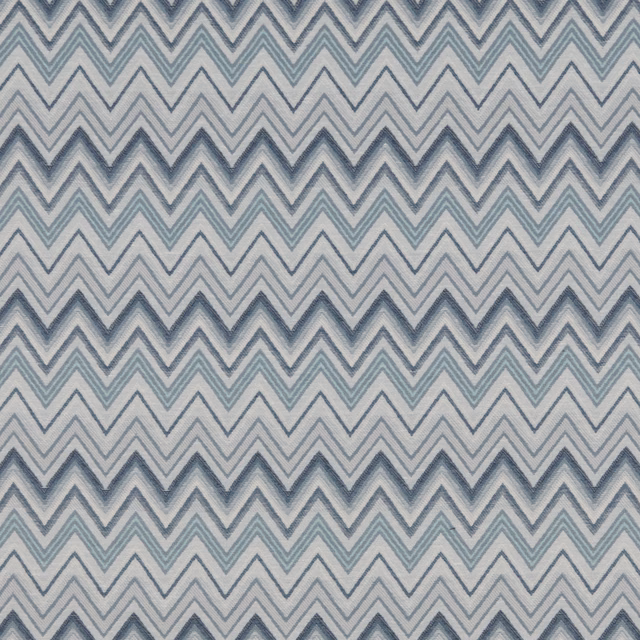 Blue-grey chevron fabric with soft aqua zigzags on an ivory ground