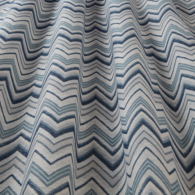 Blue and aqua wavy zigzag fabric with a pale ground and textured weave