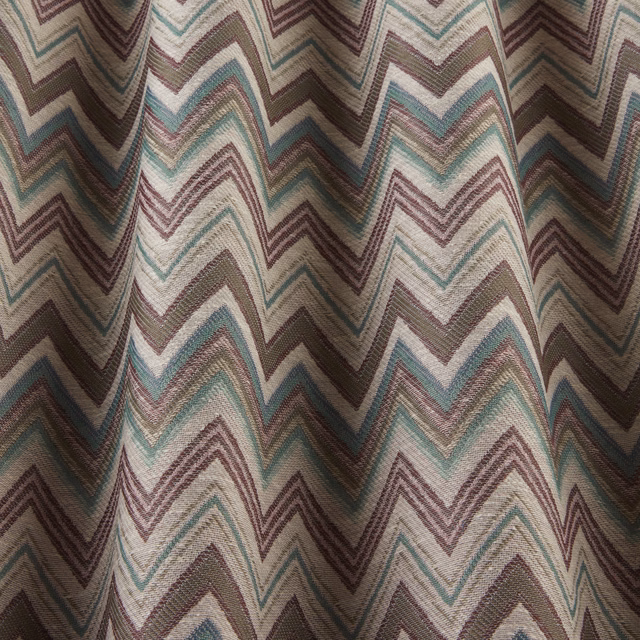 Woven zigzag fabric in damson, teal and sage on a pale ground