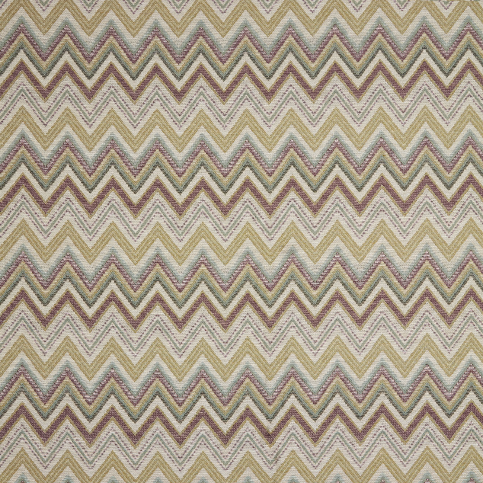 Soft zigzag fabric in moss, lilac and taupe on an ivory ground