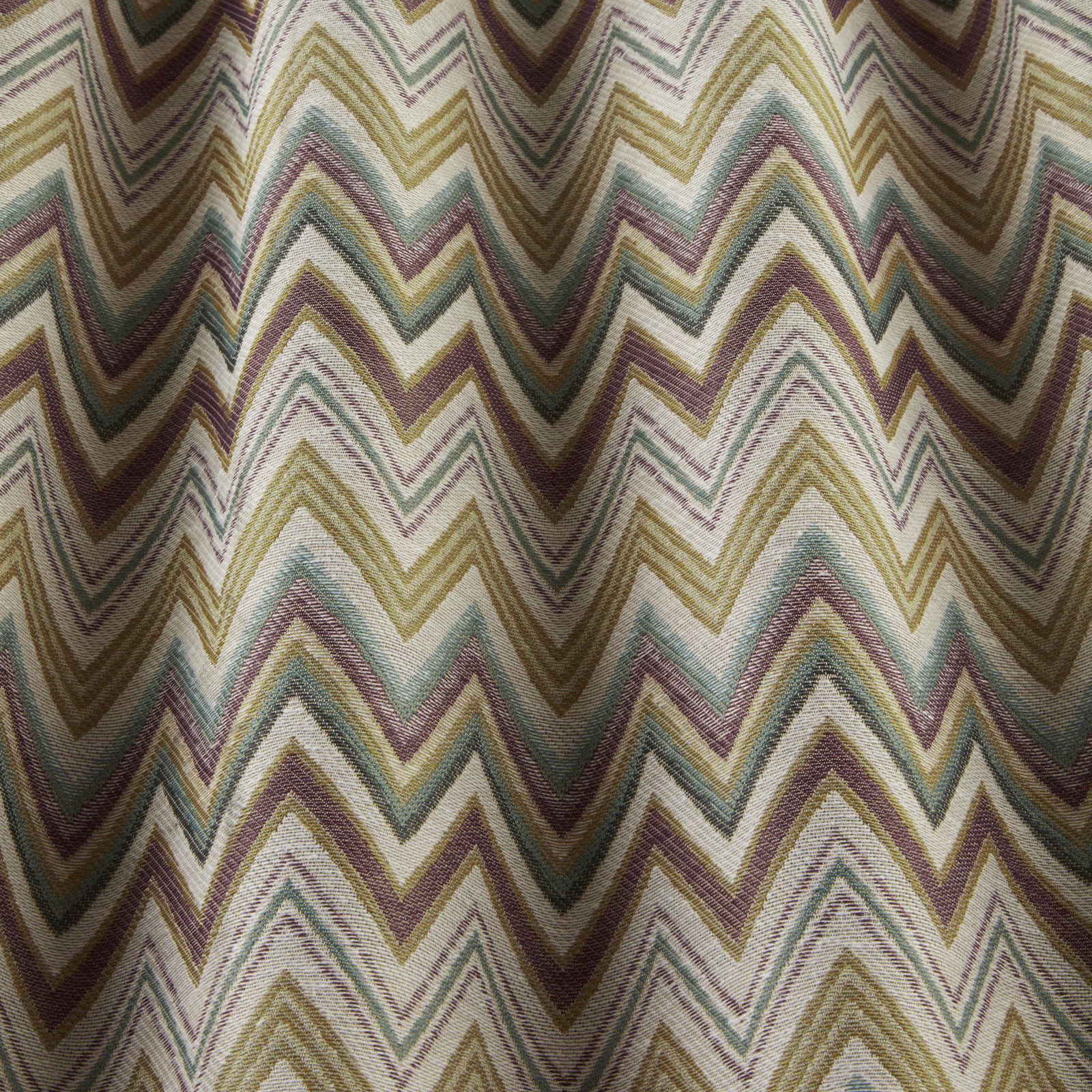 Woven chevron fabric in sage, lilac, ochre and taupe zigzags
