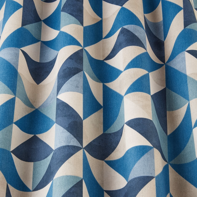 Blue and cream geometric wave fabric with large folded arcs and angular repeats