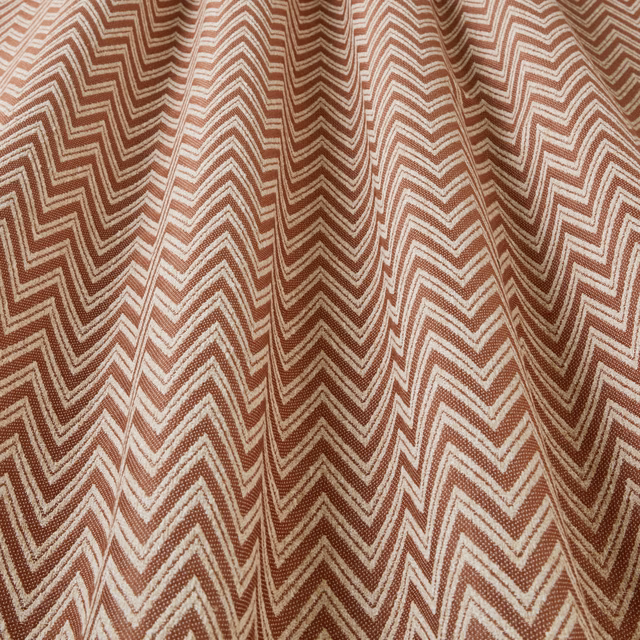 Terracotta and cream zigzag woven fabric with a textured geometric pattern