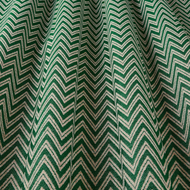 Green and ivory zigzag woven fabric with textured chevron stripes