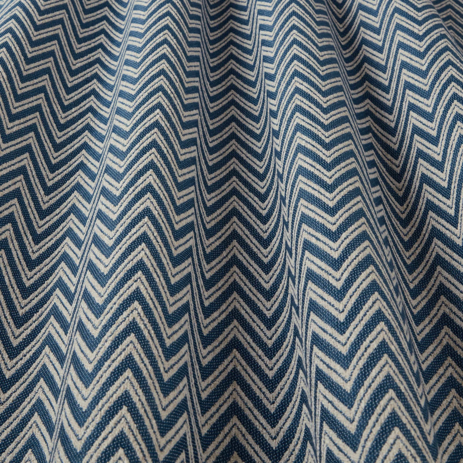 Teal blue and ivory zigzag woven fabric with a large chevron pattern