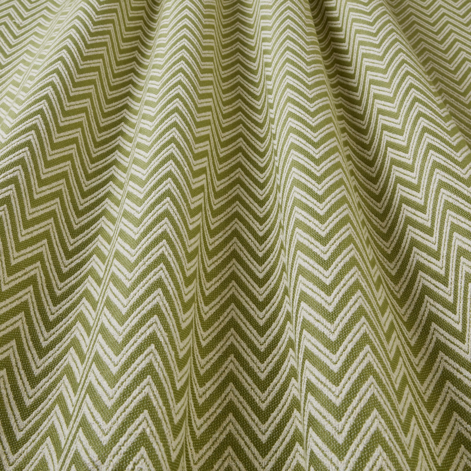 Olive green zigzag woven fabric with pale chevron lines and soft folds