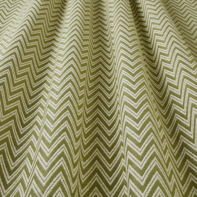 Olive green zigzag woven fabric with pale chevron lines and soft folds
