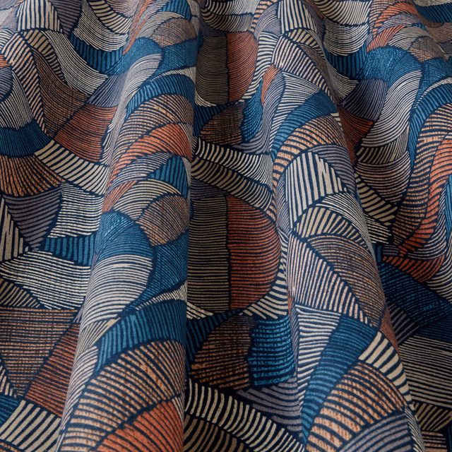 Folded geometric fabric with navy, teal, cream and terracotta wave stripes
