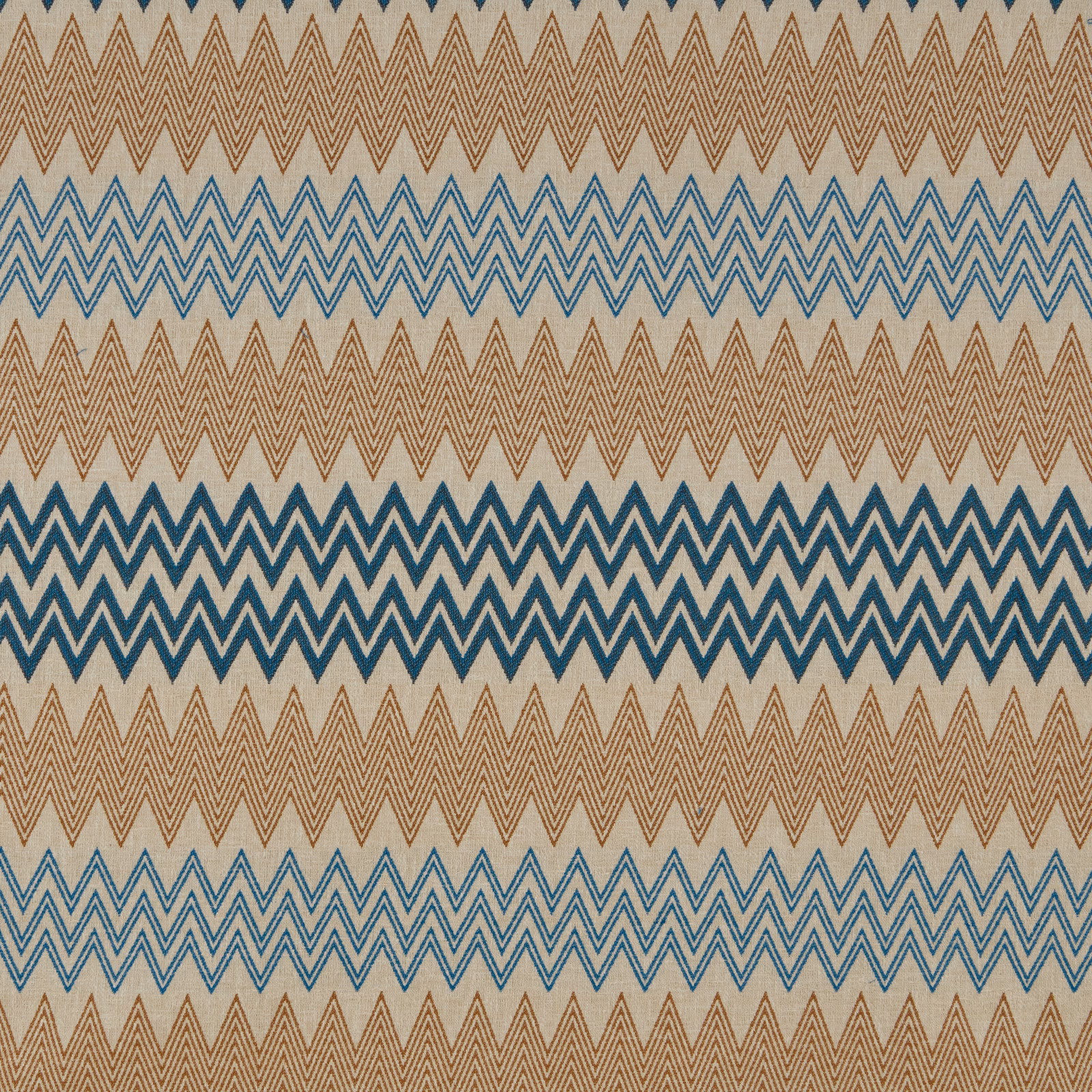 Teal-blue and terracotta zigzag chevron fabric on a pale ground