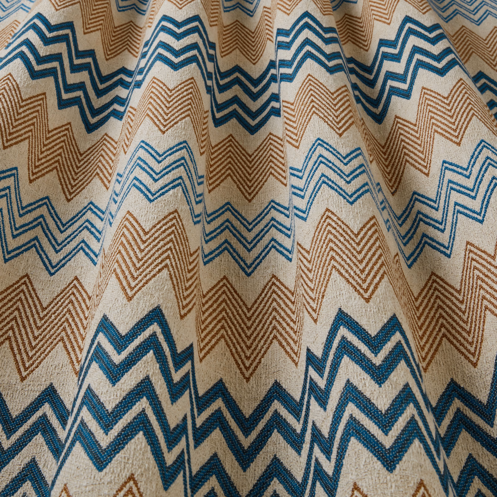 Teal and caramel zigzag woven fabric on a warm ivory ground