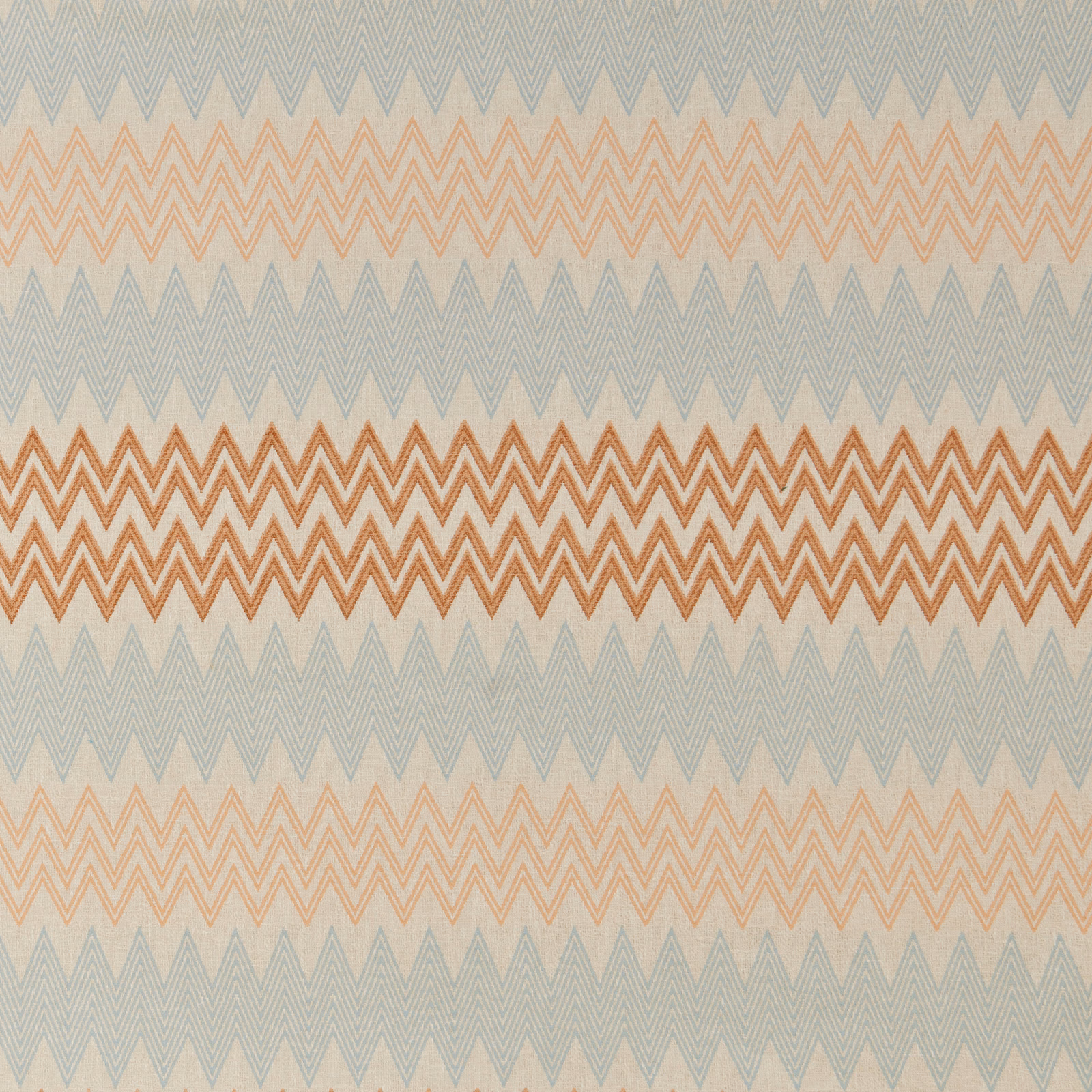 Mandarin and peach zigzag geometric fabric on a pale blue-grey ground
