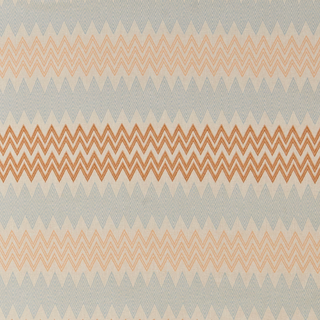 Mandarin and peach zigzag geometric fabric on a pale blue-grey ground