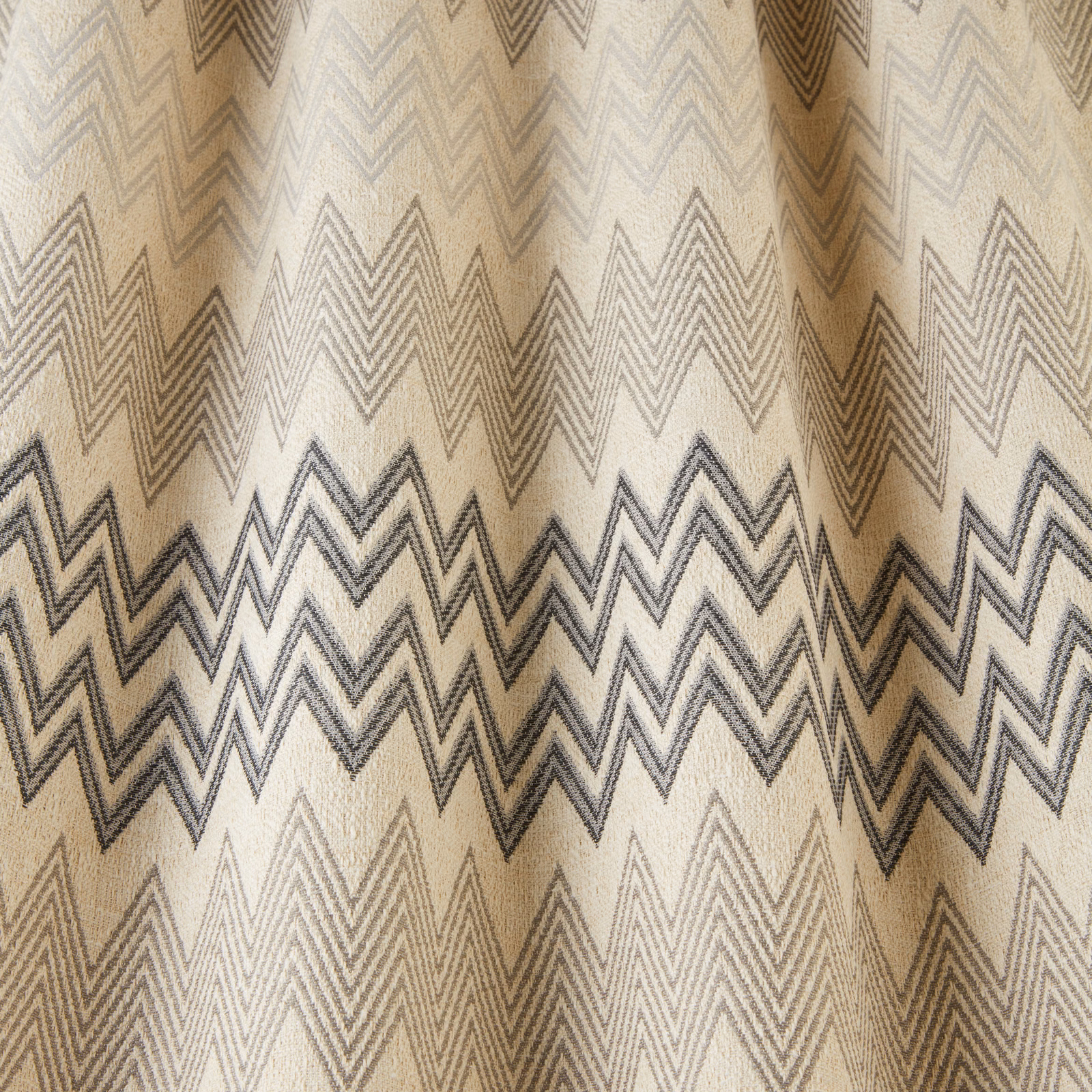 Beige fabric swatch with onyx and taupe zigzag geometric stripes