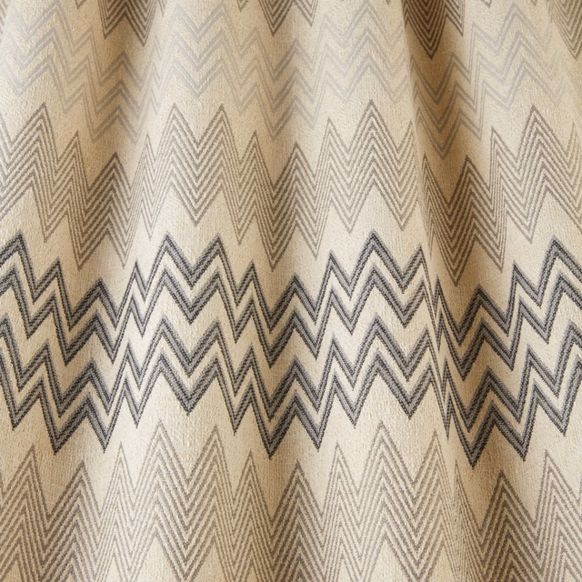 Beige fabric swatch with onyx and taupe zigzag geometric stripes