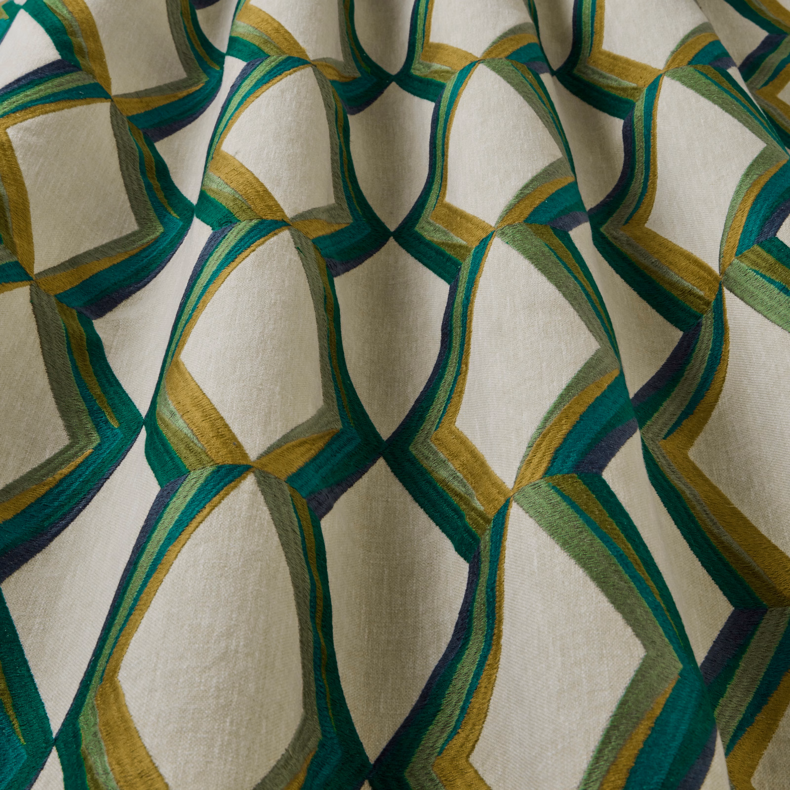 Cream fabric with large wavy geometric links in jade, teal and gold