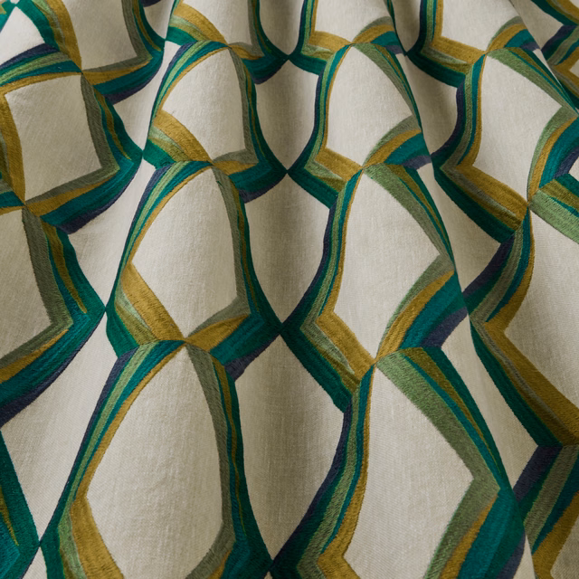 Cream fabric with large wavy geometric links in jade, teal and gold