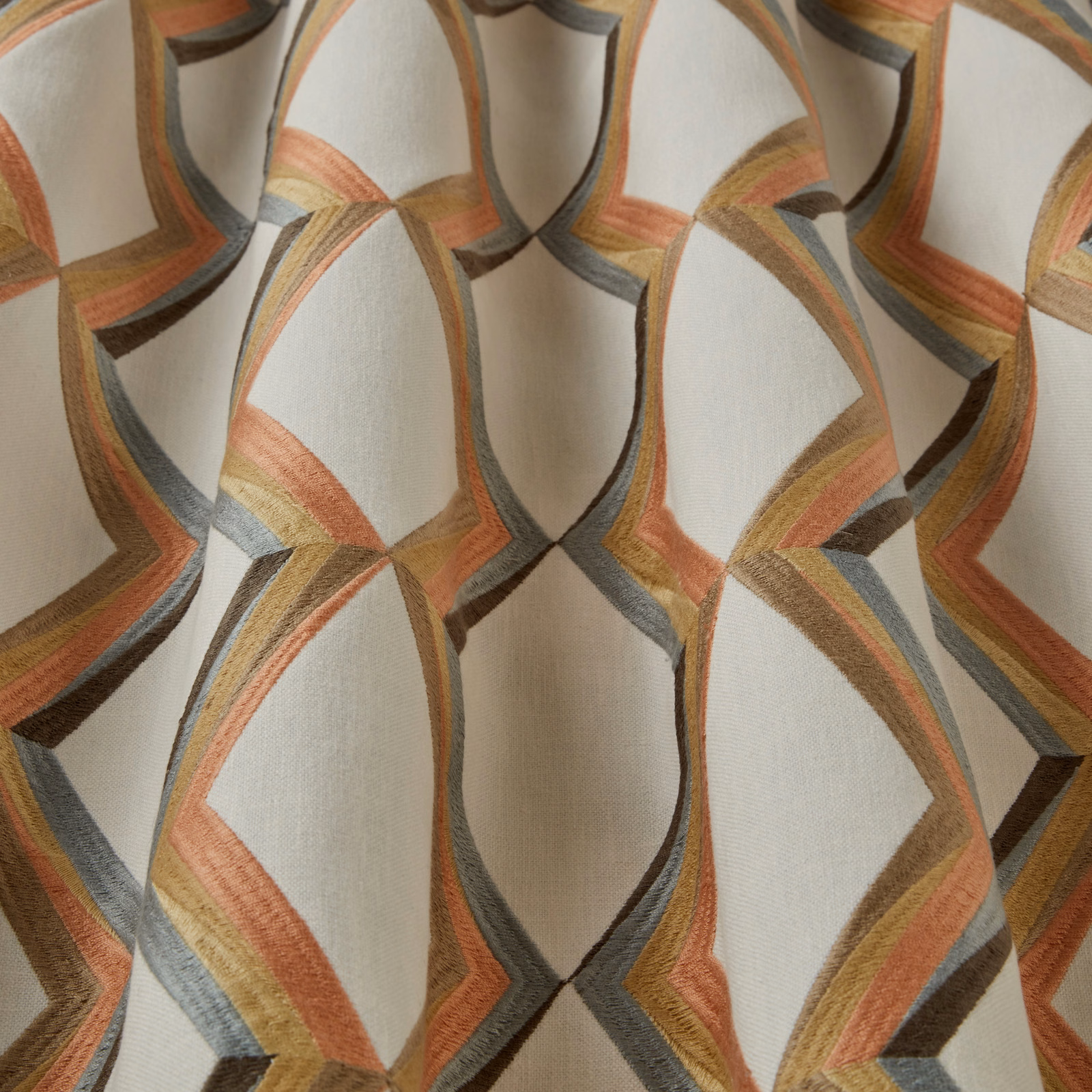 Cream ground fabric with large wavy geometric bands in mandarin, gold, grey and brown