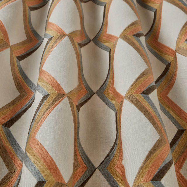 Cream ground fabric with large wavy geometric bands in mandarin, gold, grey and brown
