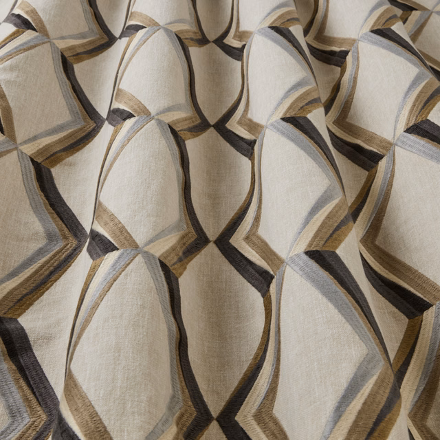 Large geometric arc pattern in mineral beige, grey, taupe and black on woven fabric